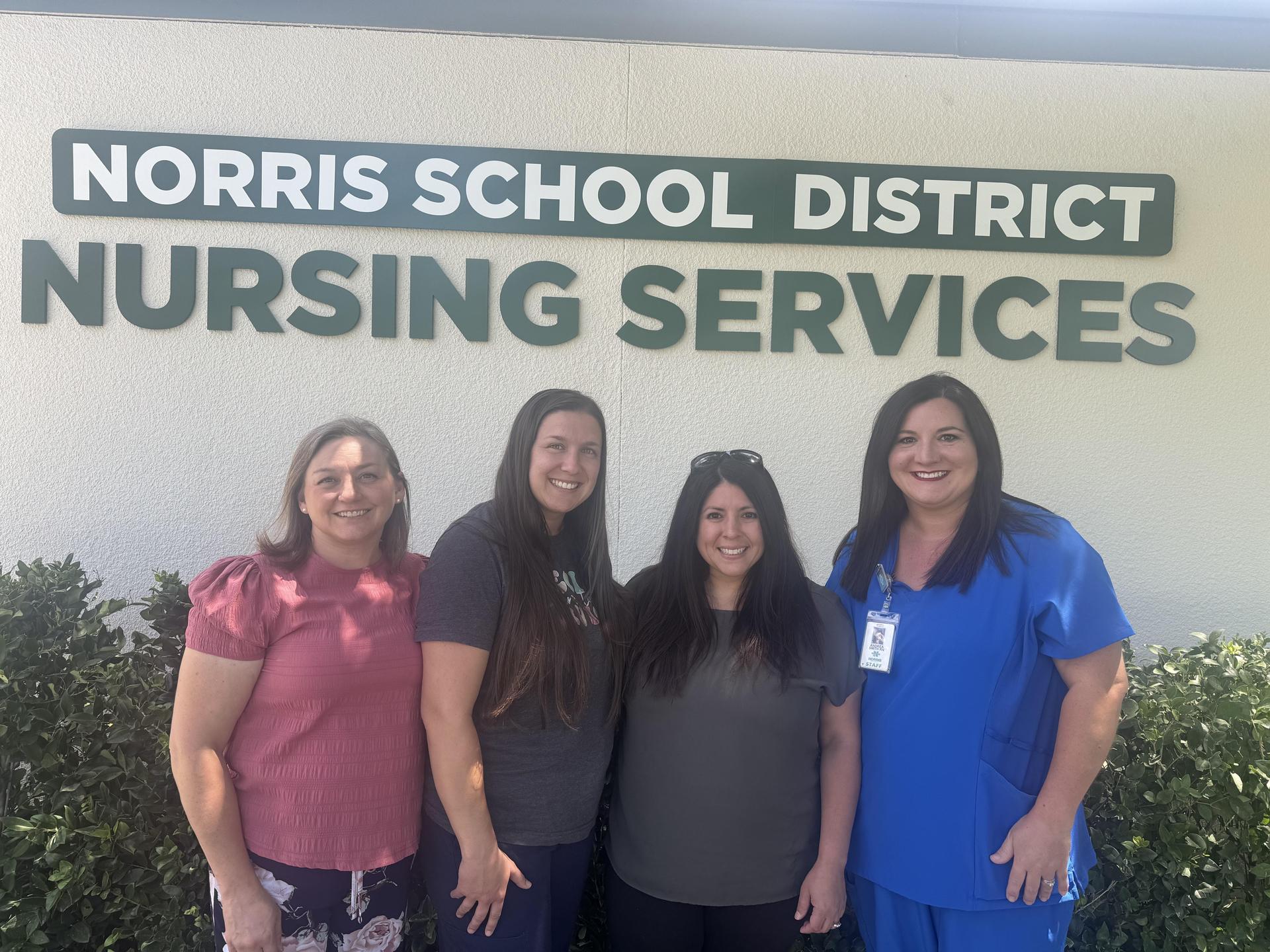The Norris School District Nursing Services team standing together outside the Nursing Services entrance.